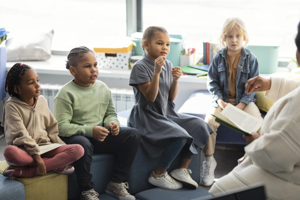 female-teacher-reading-her-pupils