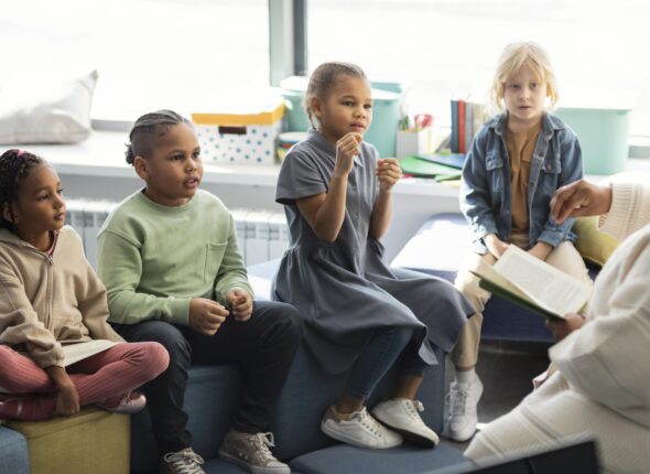 female-teacher-reading-her-pupils